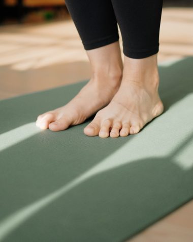 a person standing on a yoga mat on the floor