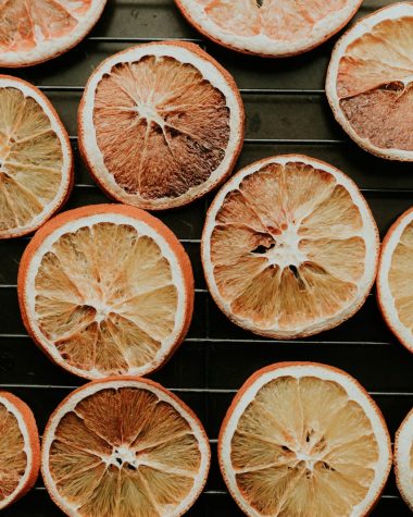 a bunch of oranges that are on a rack