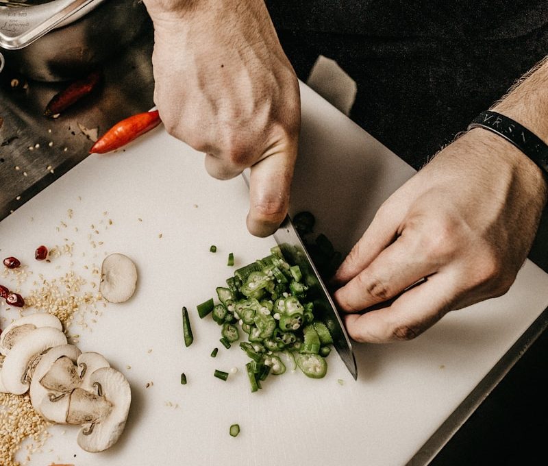 person slicing vegetable