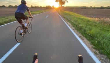 man in black shirt riding bicycle on road during daytime