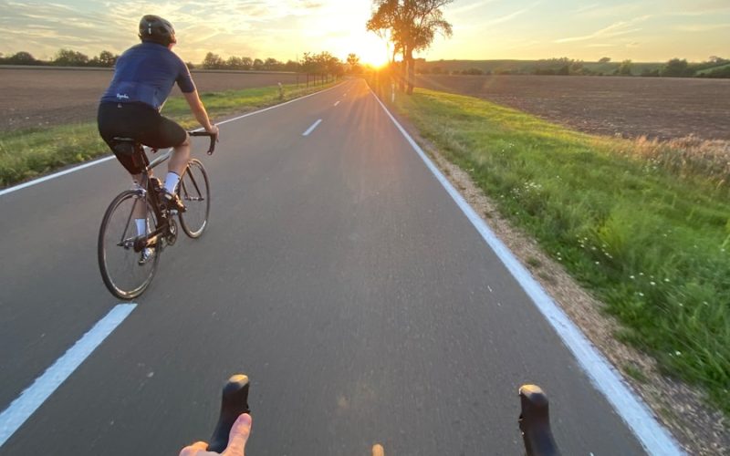 man in black shirt riding bicycle on road during daytime