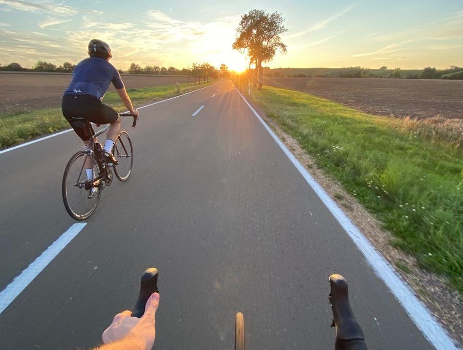 man in black shirt riding bicycle on road during daytime