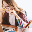 Persoon die zich uitrekt achter een bureau op kantoor